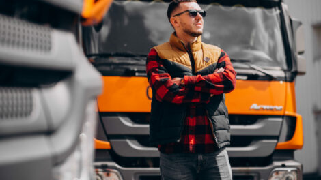 handsome-man-truck-driver-standing-by-truck