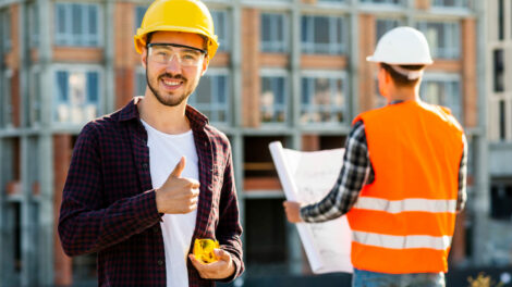 medium-shot-portrait-smiling-architect-looking-camera