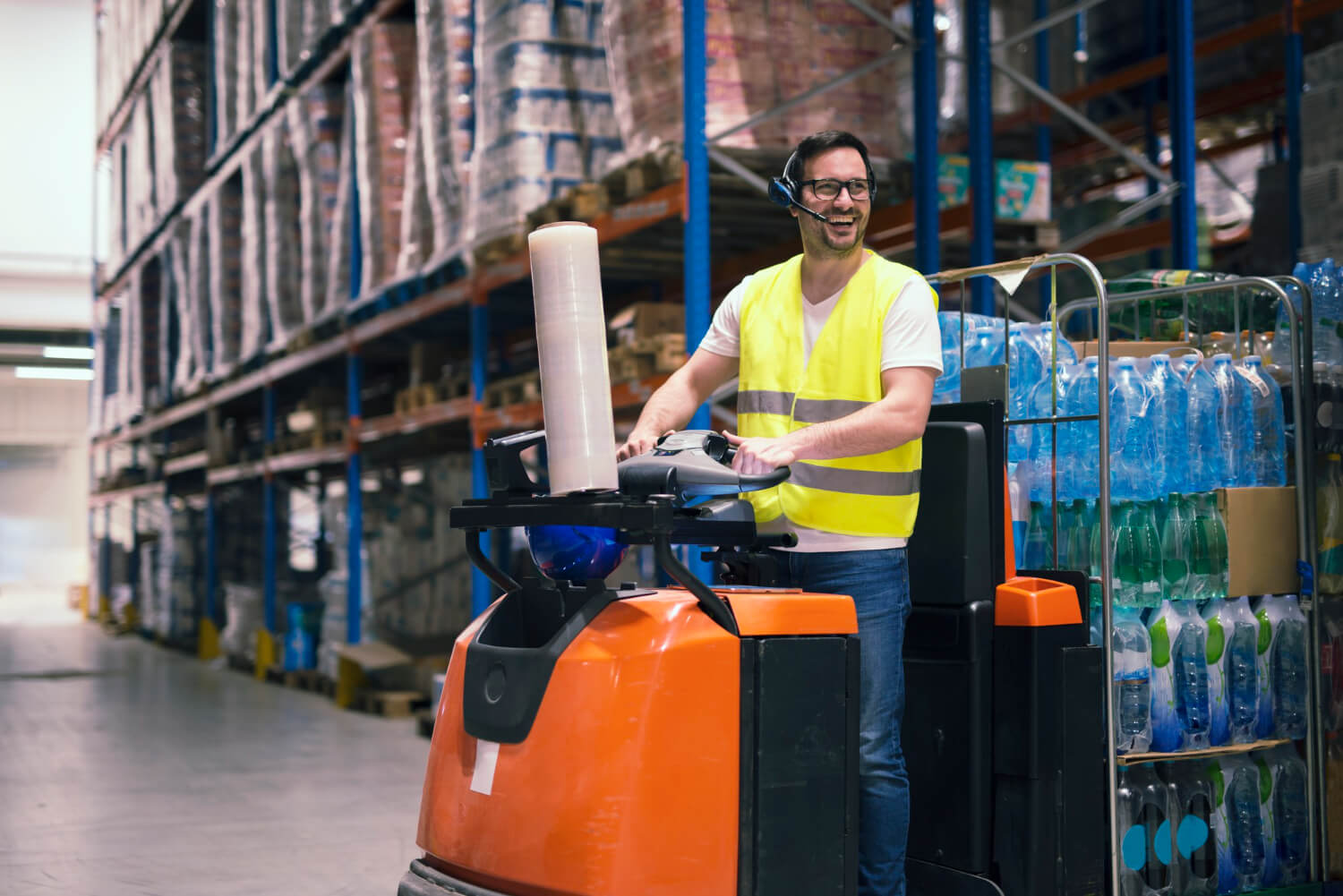 professional-warehouse-worker-with-headset-communication-equipment-driving-forklift-relocating-packages-storage-center-1-1